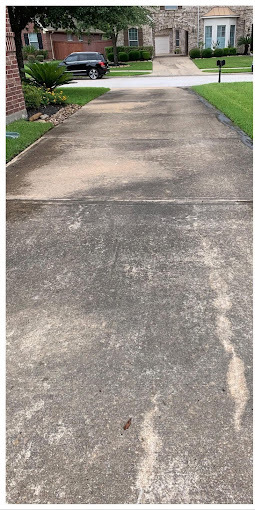 Driveway before pressure washing, gray with traffic stains