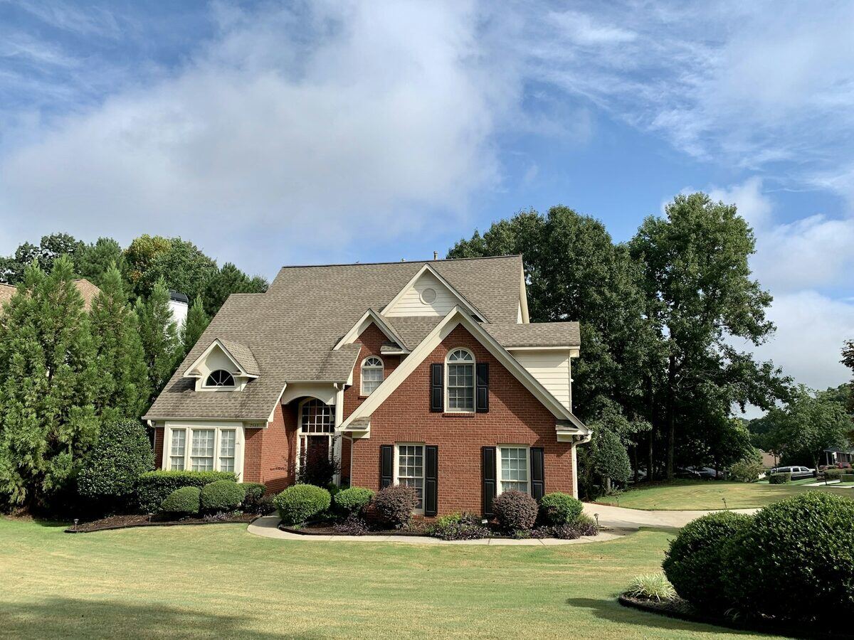 A freshly washed two-story brick home in the Tulsa area on a clear day